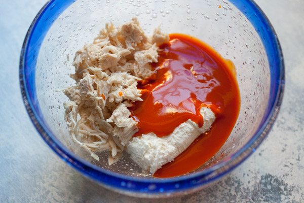 mixing ingredients for Easy Buffalo Chicken Wonton Cups 