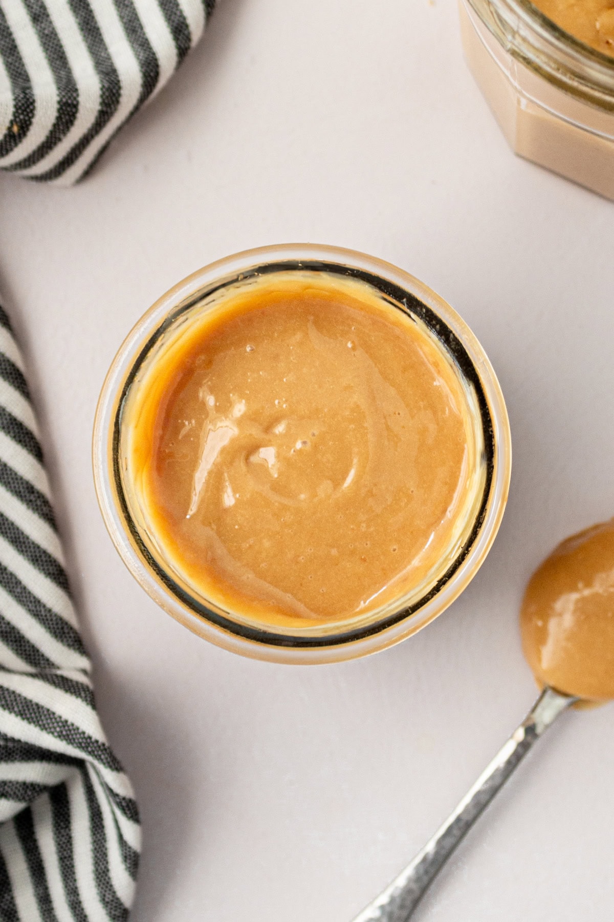 Homemade Dulce de Leche recipe made in the oven: by RecipeGirl.com overhead shot of jar of dulce de leche