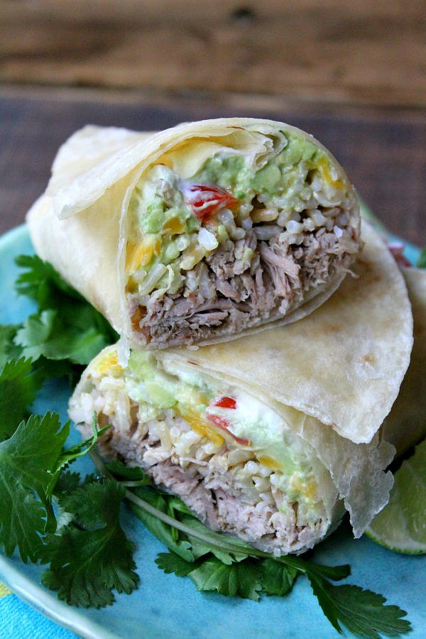 Slow Cooker Carnitas Burritos cut in half