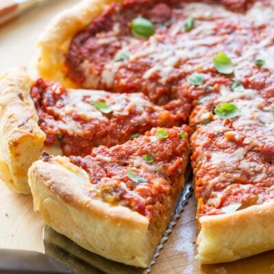 chicago deep dish pizza pulling out slices with a spatula