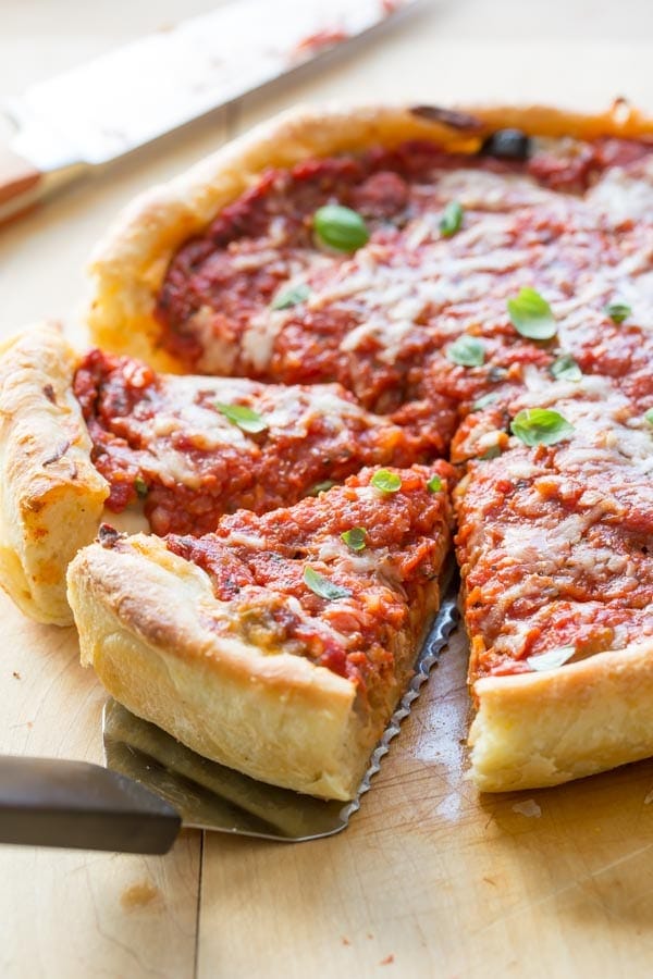 chicago deep dish pizza pulling out slices with a spatula