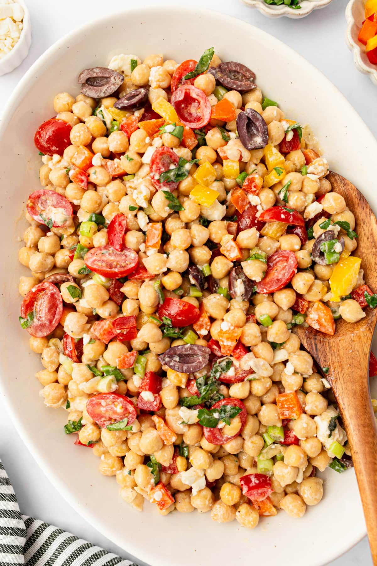 This Mediterranean Chickpea Salad is a super popular, delicious and easy salad recipe from RecipeGirl.com. mediterranean chickpea salad in bowl with spoon