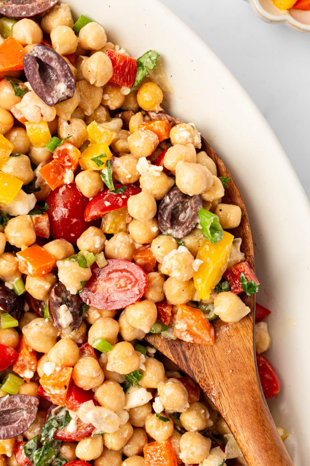 This Mediterranean Chickpea Salad is a super popular, delicious and easy salad recipe from RecipeGirl.com. close up mediterranean chickpea salad in bowl