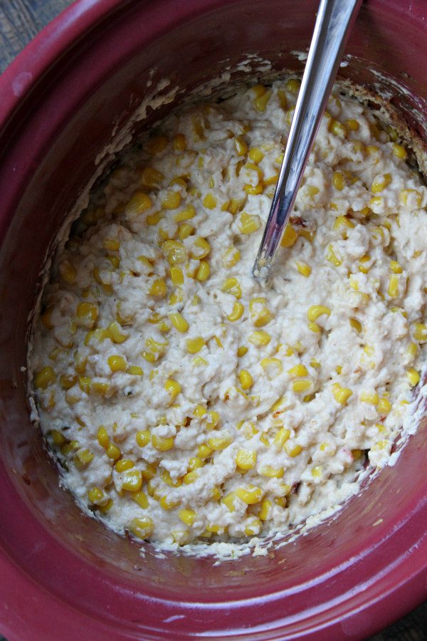 Slow Cooker Mexican Street Corn Dip recipe from RecipeGirl.com : Elote Dip : Corn Dip : Crockpot Mexican Street Corn Dip Mexican Street Corn Dip cooking in the Slow Cooker with a serving spoon