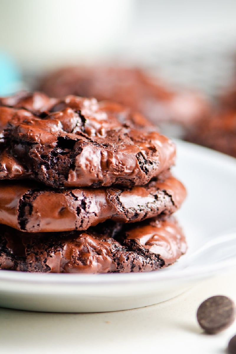 stack of three chocolate cookies on white plate