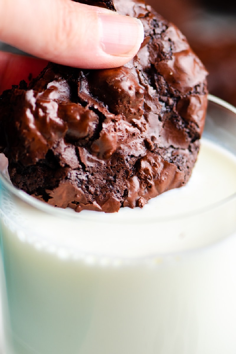 dipping a chocolate cookie into milk