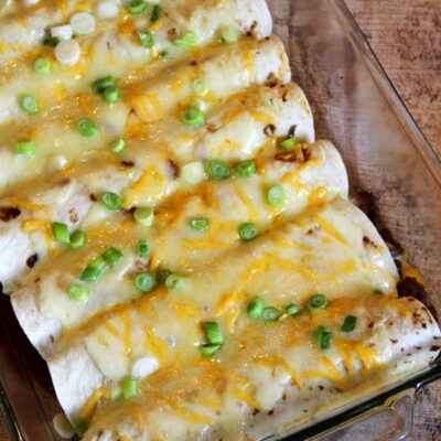 overhead shot of beef burrito casserole with melted cheese and green onions on top