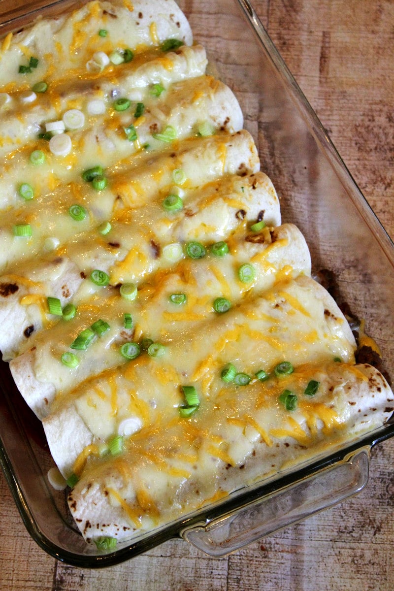 overhead shot of beef burrito casserole with melted cheese and green onions on top
