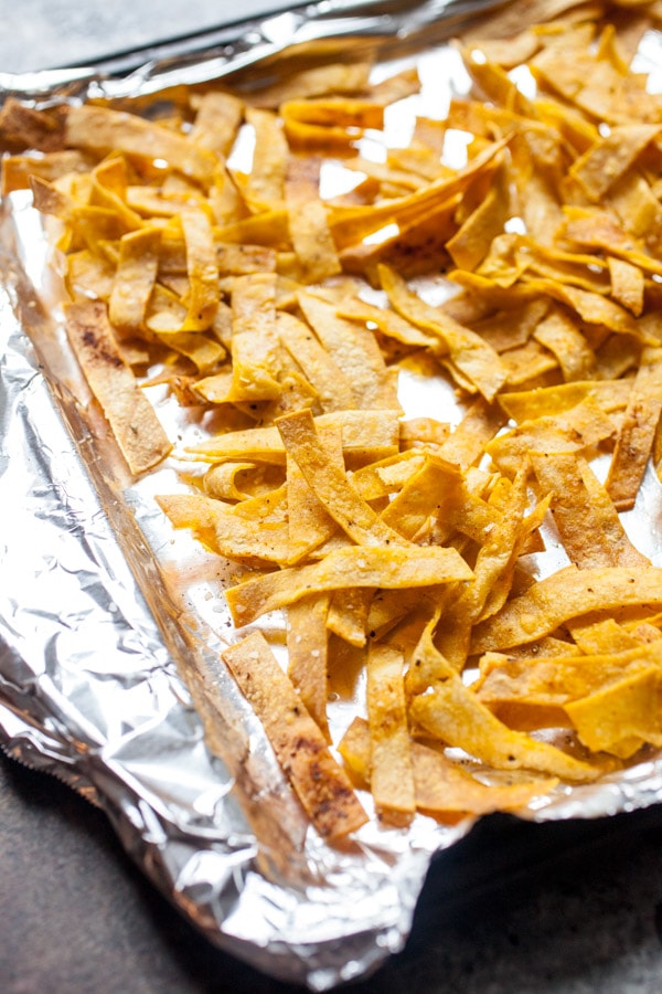 Crispy Tortilla Strips on a foil lined baking sheet