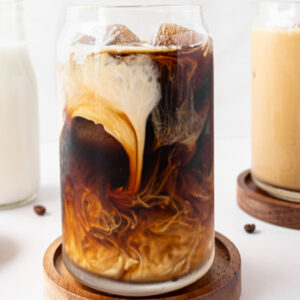 iced coffee in glass with cream swirl