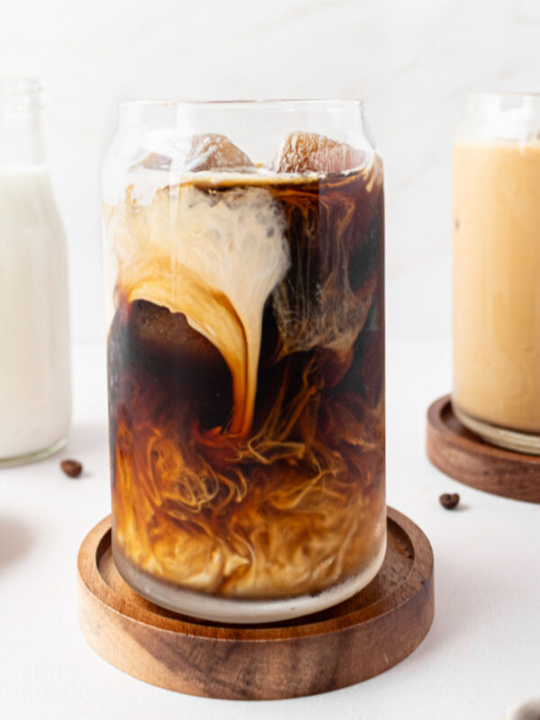 iced coffee in glass with cream swirl