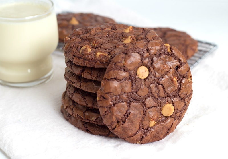 Chocolate Wow Cookies in a stack with a glass of milk on the side