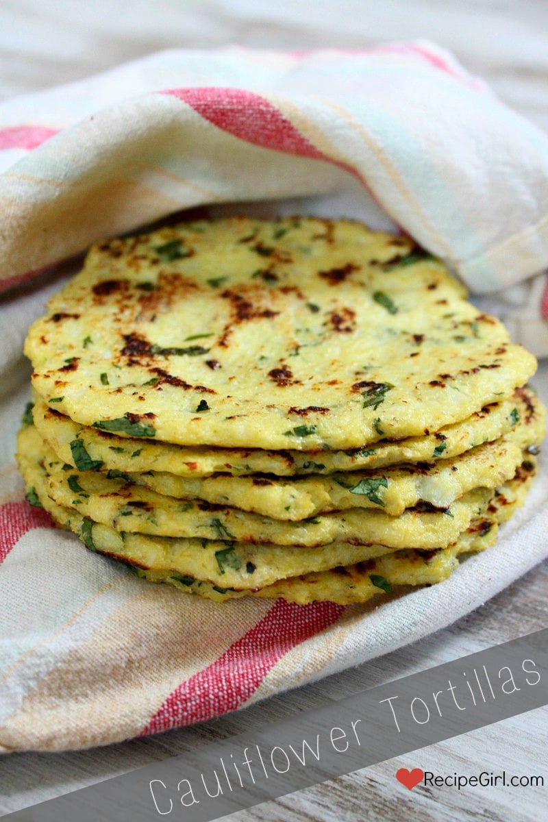 stack of cauliflower tortillas in a striped cloth napkin