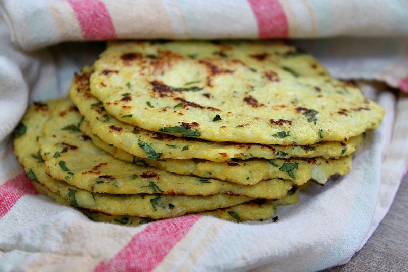 stack of cauliflower tortillas in a striped cloth napkin