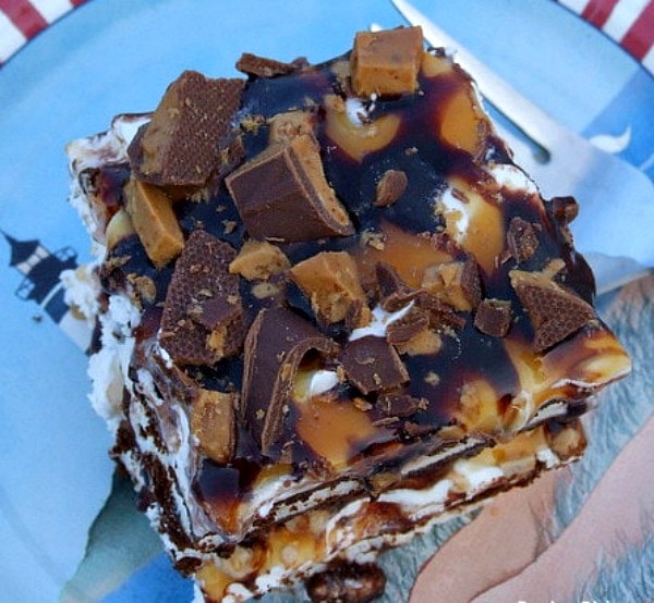 overhead shot of slice of frozen caramel toffee ice cream sandwich dessert on a blue plate