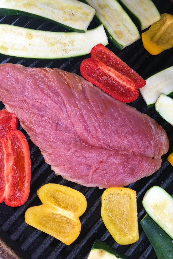 Grilling pork tenderloin and vegetables on the grill