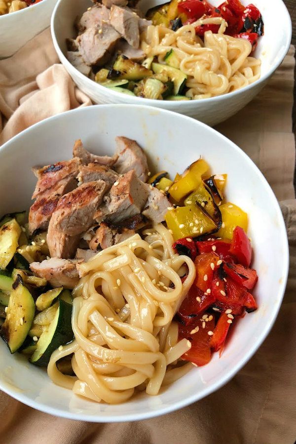 Two Grilled Pork and Vegetable Teriyaki Noodle Bowls in white bowls