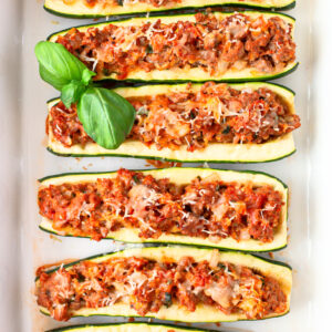 sausage stuffed zucchini in a baking pan