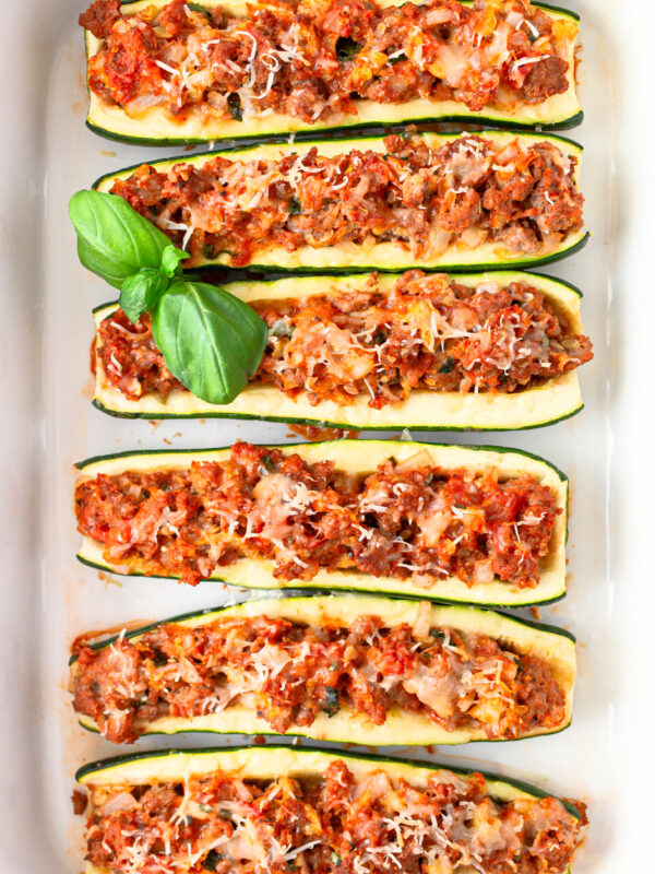 sausage stuffed zucchini in a baking pan