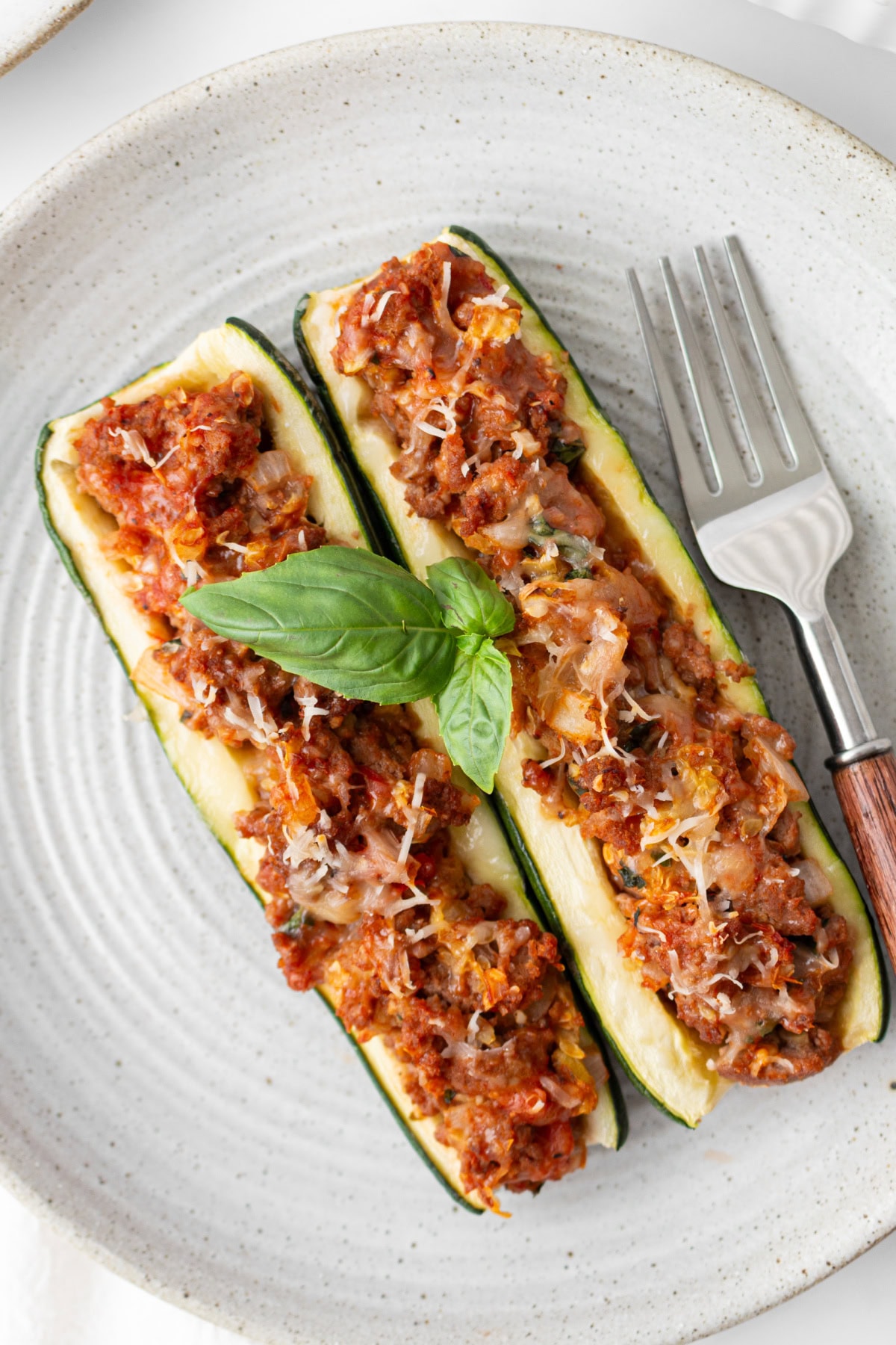 Sausage Stuffed Zucchini Boats Recipe : from RecipeGirl.com : summer zucchini recipe two sausage stuffed zucchini on a plate with a fork