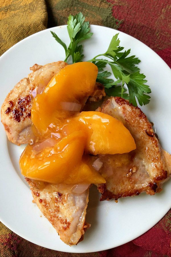 Pork with Peach Sauce on a white plate