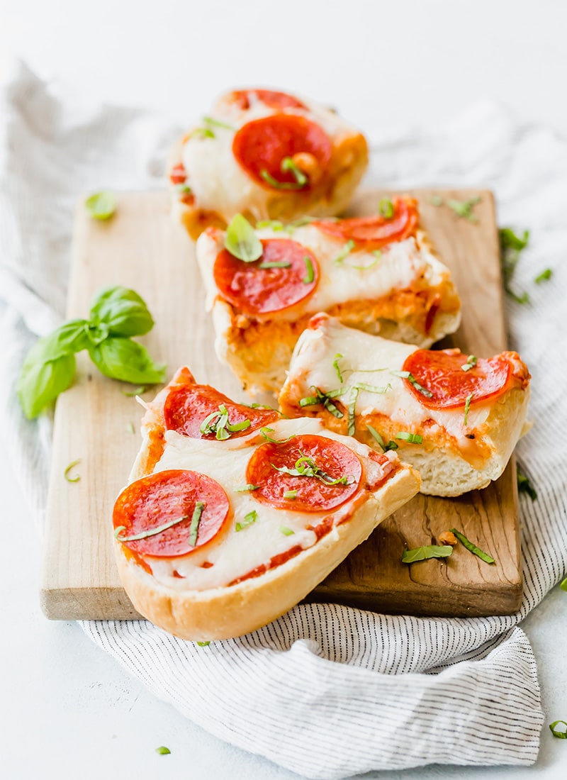 French Bread Pizza with Pepperoni and Fresh Basil cut into slices