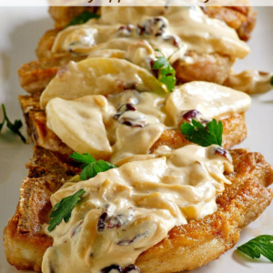 pinterest image for pork chops with creamy apple cranberry sauce