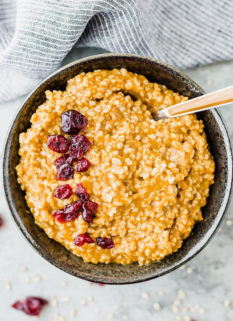 Pan of Pumpkin Steel Cut Oats garnished with dried cranberries