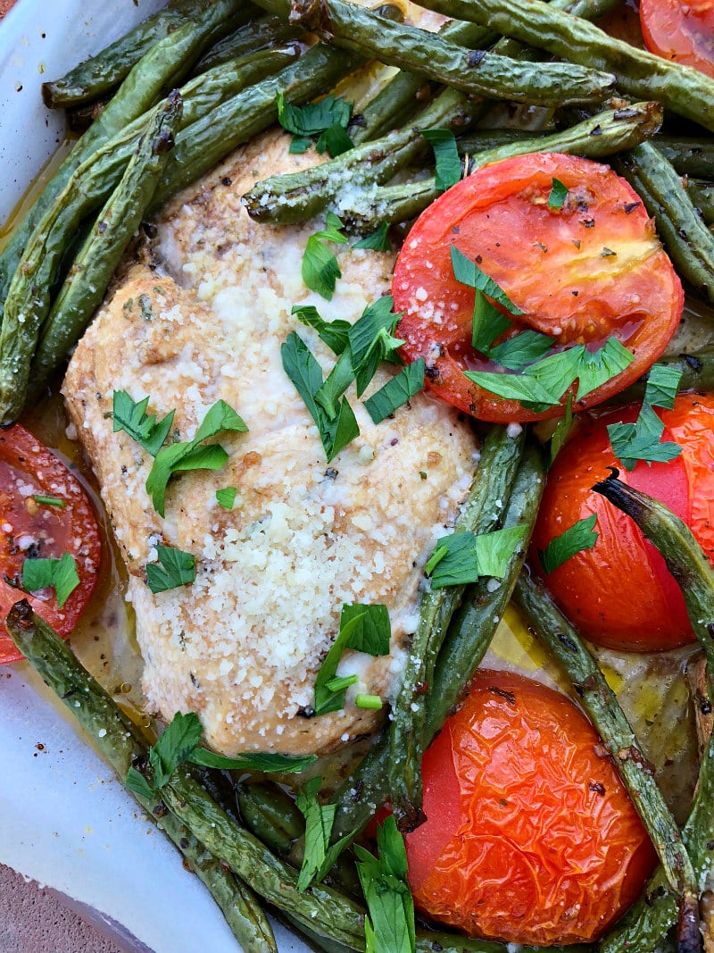 Tuscan Chicken Sheet Pan Dinner with roasted green beans and blistered tomatoes