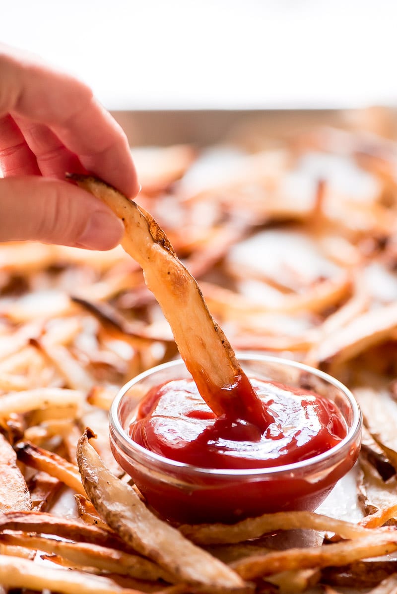 Baked French Fries dipped in ketchup