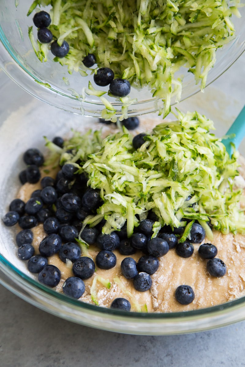 Adding zucchini and blueberries to the batter for a Blueberry Zucchini Sheet Cake