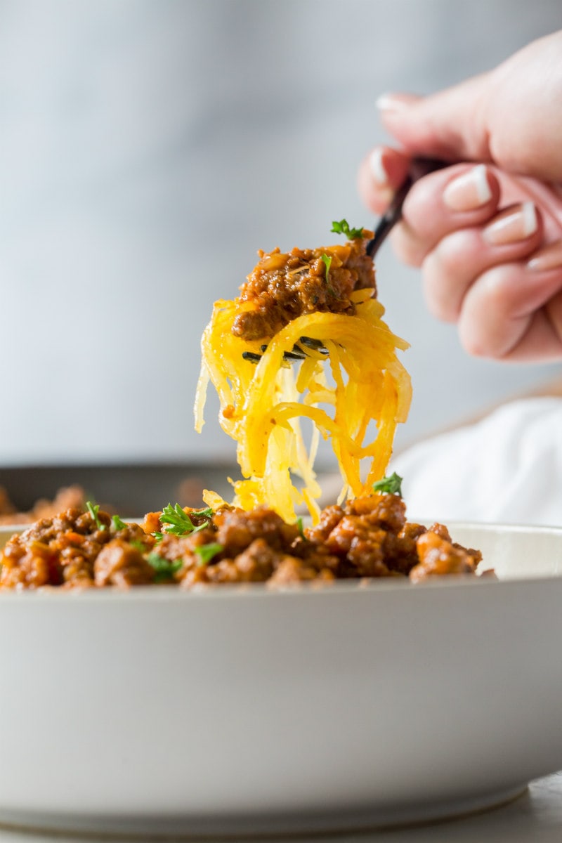 Paleo Spaghetti Squash Bolognese recipe from RecipeGirl.com #paleo #spaghetti #squash #spaghettisquash #bolognese #recipe #RecipeGirl A forkful of Spaghetti Squash Bolognese