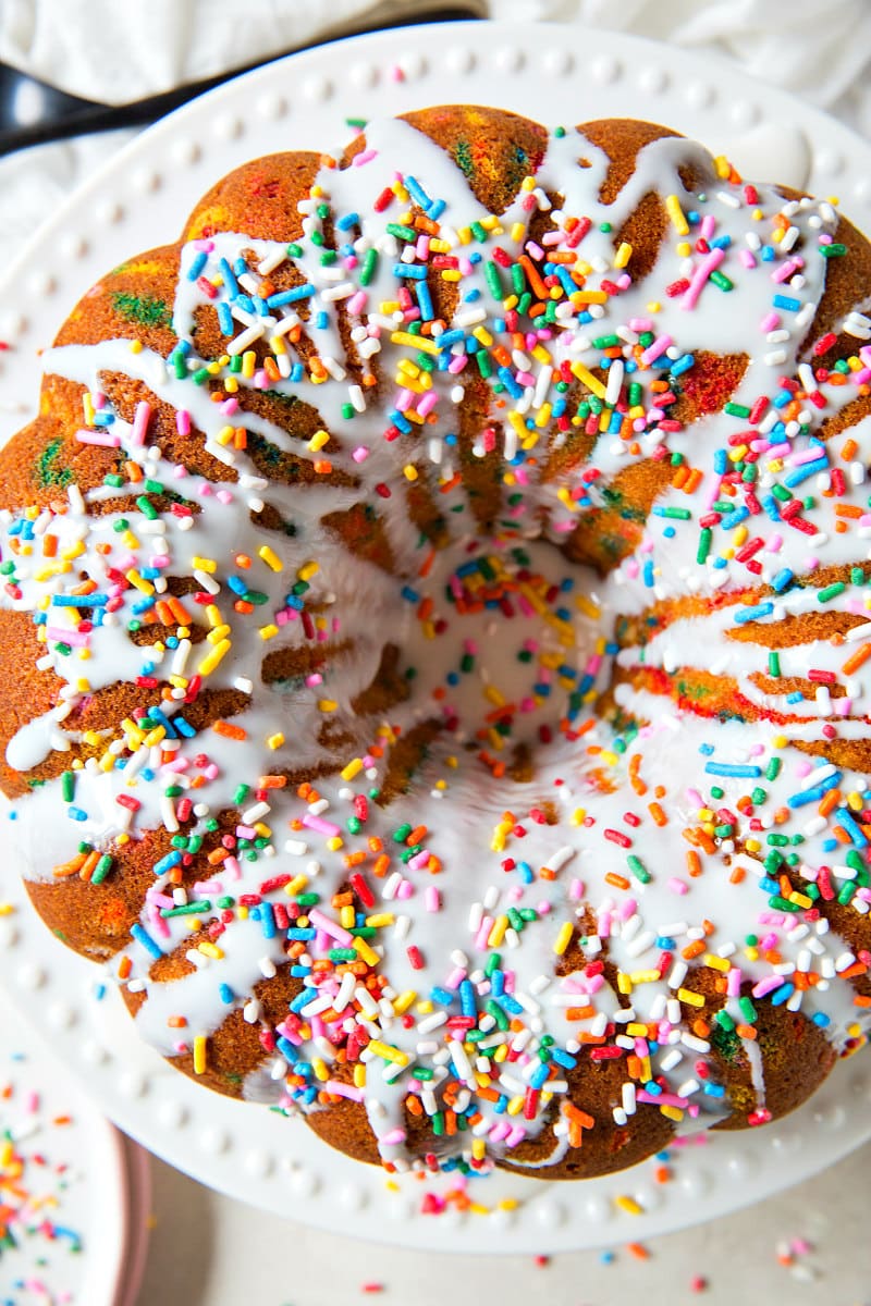 Funfetti Bundt Cake covered with white chocolate glaze and rainbow sprinkles