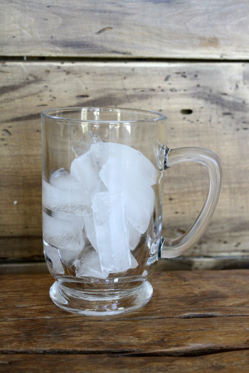 mug of ice displayed with a wood background