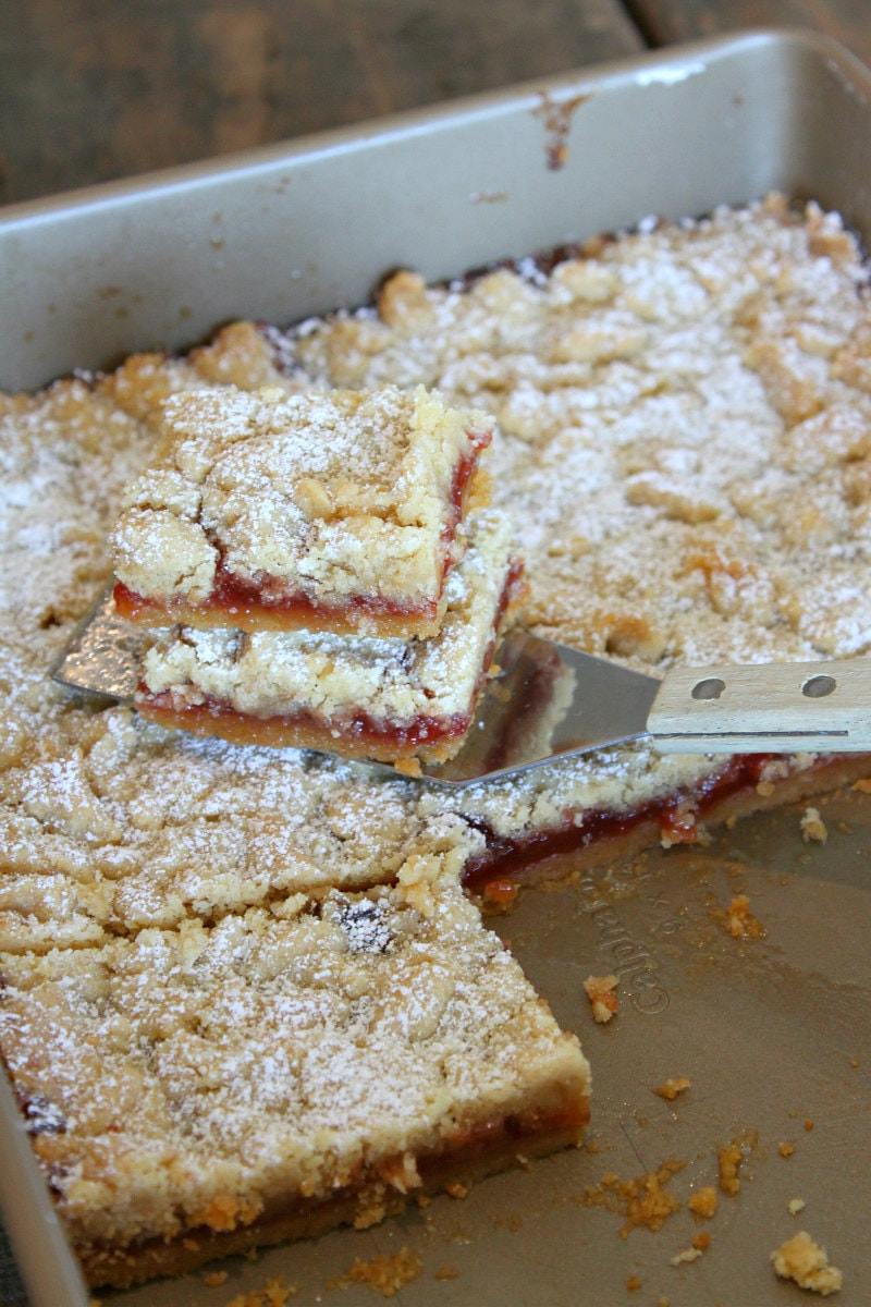 cutting up and serving Strawberry Shortbread Bars out of the pan