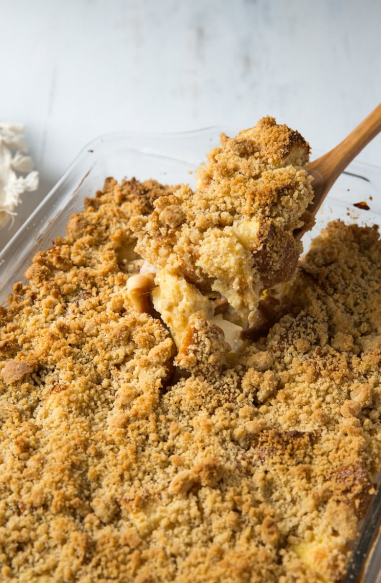 a spoon serving peach cobbler french toast casserole