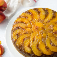 peach upside down cake on a white plate