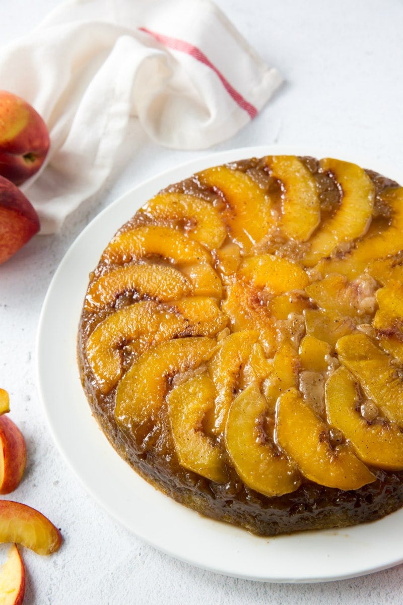 peach upside down cake on a white plate