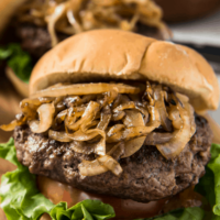 jucy lucy burger piled high with grilled onions