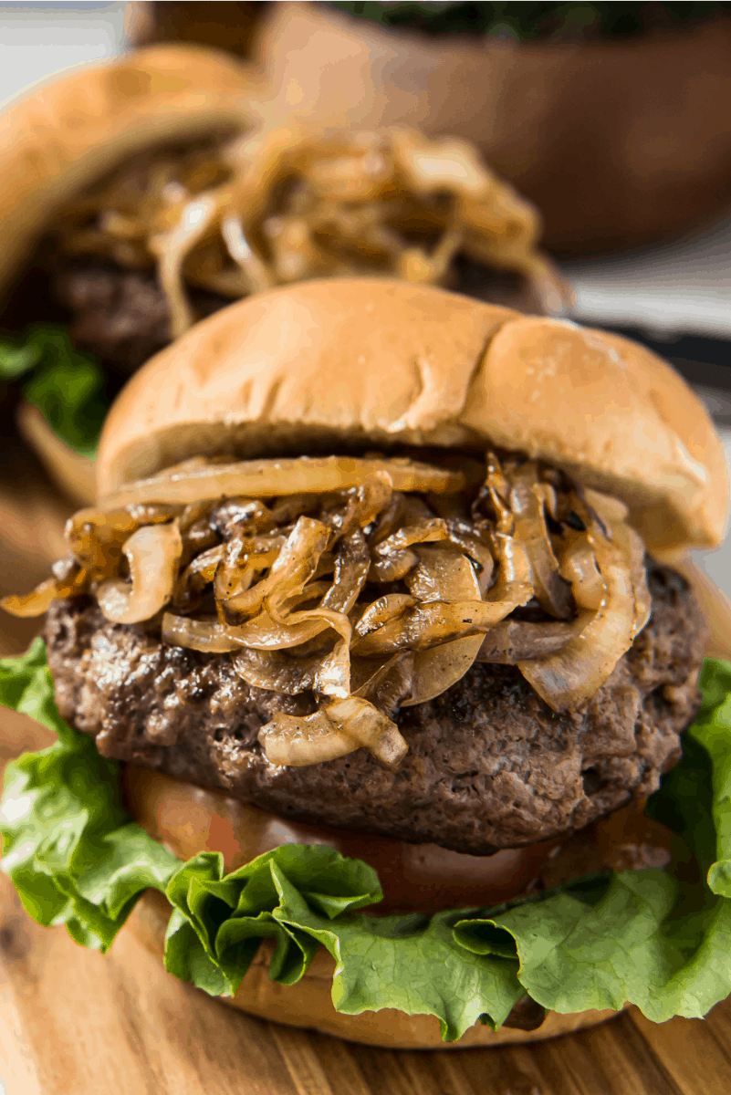 jucy lucy burger piled high with grilled onions