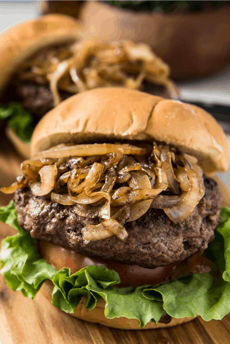 Jucy Lucy Burgers recipe from RecipeGirl.com #jucy #juicy #lucy #burger #burgers #minneapolis #copycat #recipe #RecipeGirl jucy lucy burger with grilled onions piled high