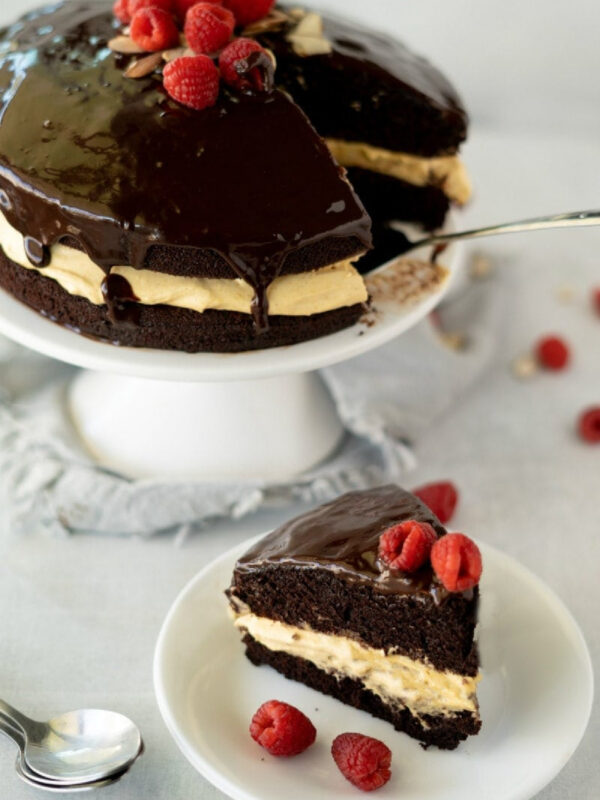 chocolate pumpkin cake with cream cheese filling on a cake stand and slice on plate