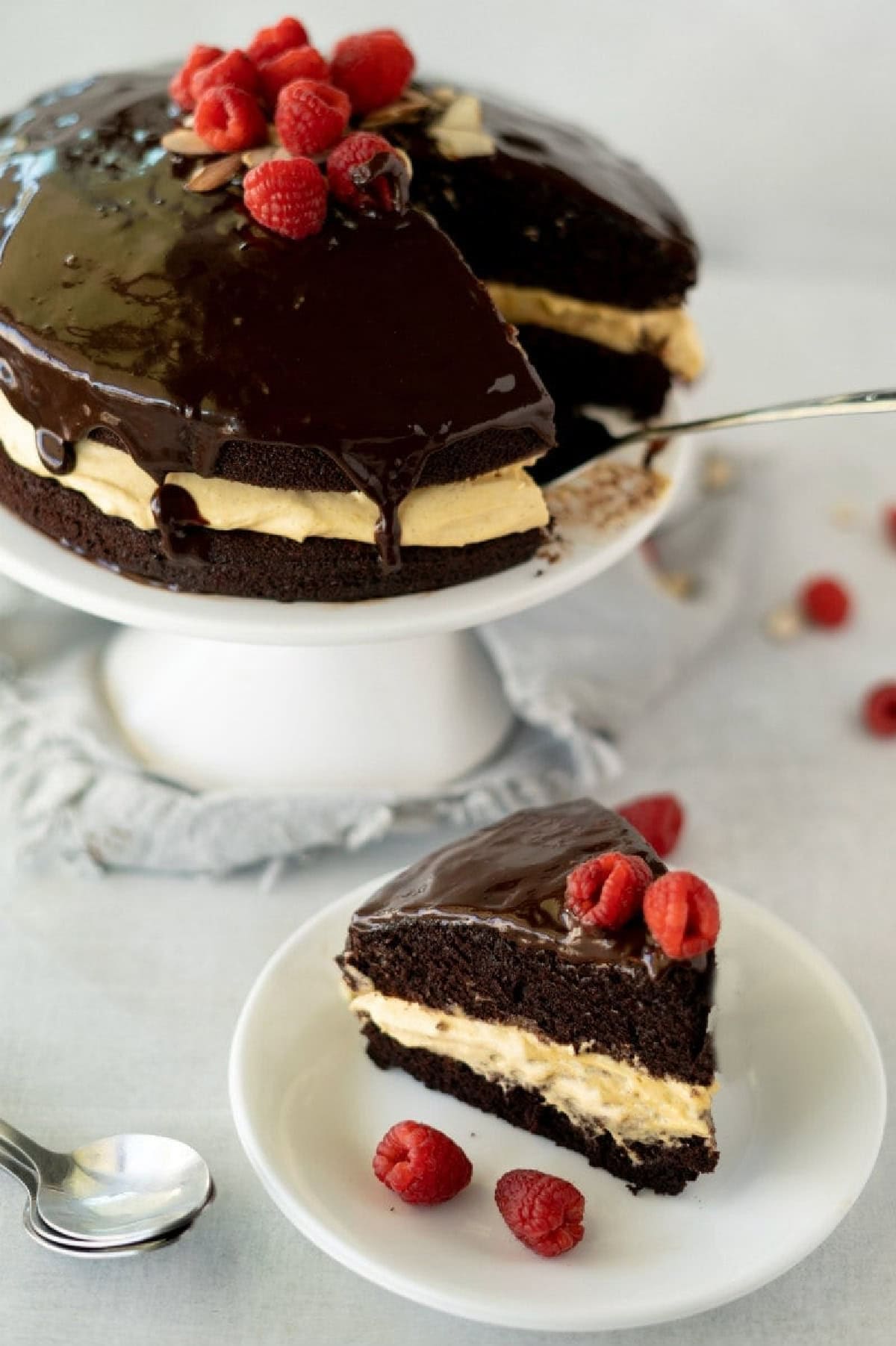 chocolate pumpkin cake with cream cheese filling on a cake stand and slice on plate
