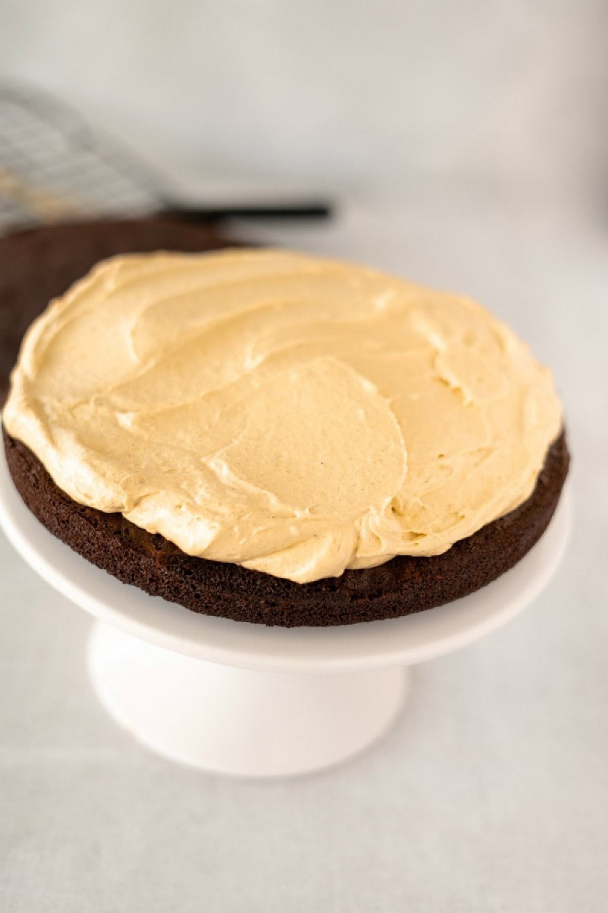 pumpkin cream cheese filling topped on a chocolate cake