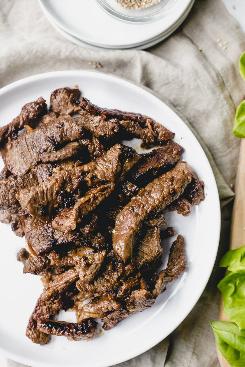 Bulgogi Beef Lettuce Wraps recipe from RecipeGirl.com #Bulgogi #korean #beef #lettuce #wraps #recipe #RecipeGirl bulgogi beef on a white plate