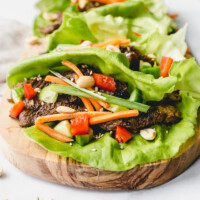 bulgogi beef lettuce wraps on a wooden cutting board