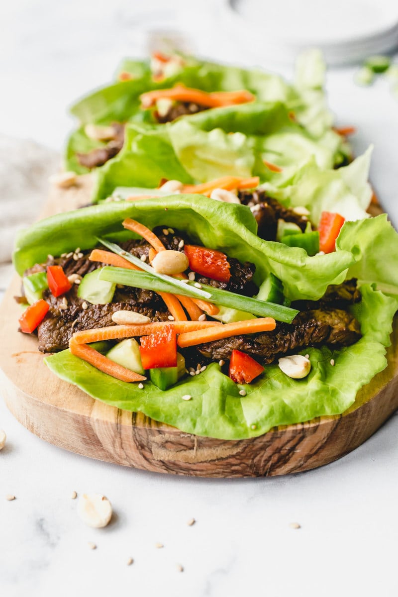 bulgogi beef lettuce wraps on a wooden cutting board