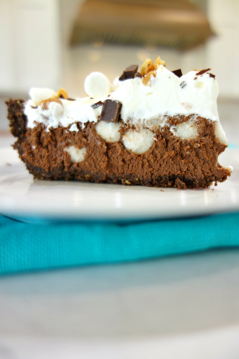 slice of rocky road pie on a white plate with a teal blue napkin
