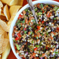 overhead shot of texas caviar in a white bowl served with tortilla chips