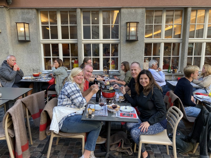 Two couples eating Fondue at a table at Swiss Chuchi in Zurich, Switzerland